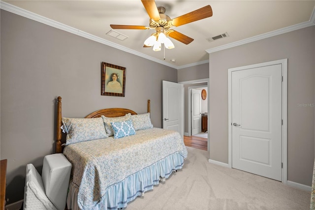 bedroom with visible vents, baseboards, light colored carpet, ornamental molding, and a ceiling fan