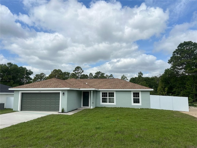 ranch-style home with fence, a front lawn, stucco siding, driveway, and a garage