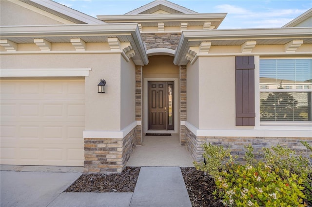 entrance to property featuring stucco siding, stone siding, and a garage