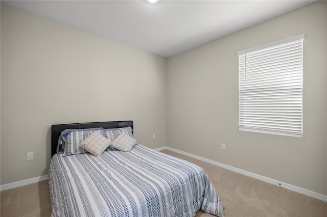 bedroom with baseboards and carpet flooring