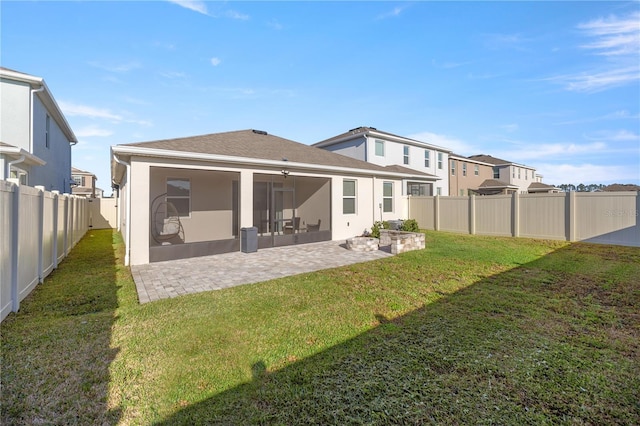 back of property featuring a patio, roof with shingles, a yard, a fenced backyard, and stucco siding