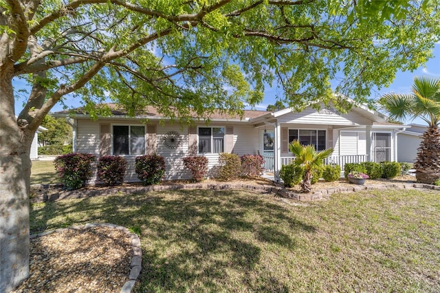 single story home featuring a porch and a front lawn