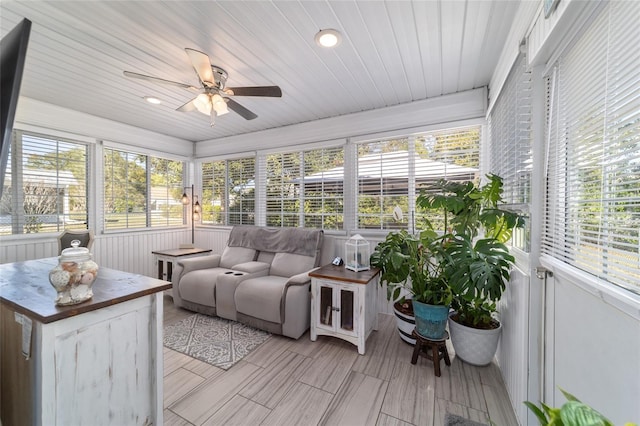 sunroom / solarium featuring a wealth of natural light, wood ceiling, and ceiling fan