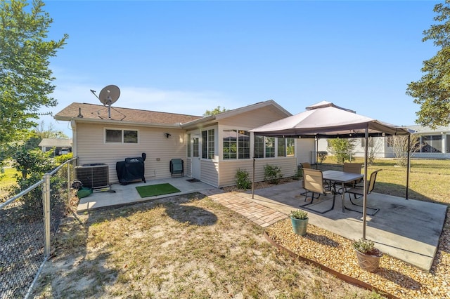 back of house with fence, a gazebo, a lawn, cooling unit, and a patio