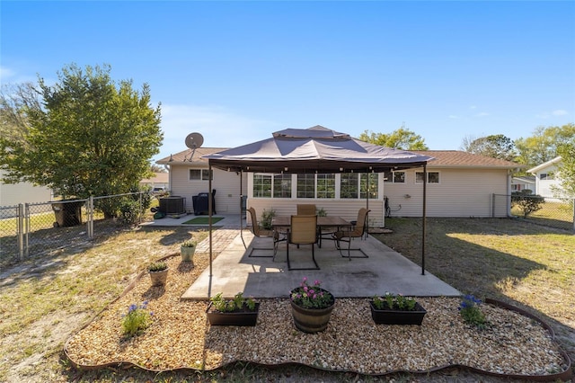 back of house featuring a fenced backyard, central air condition unit, a patio area, and a yard