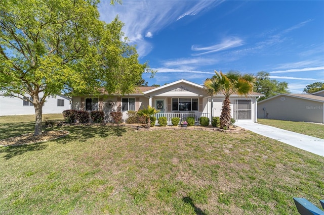 ranch-style house with a porch, concrete driveway, and a front lawn