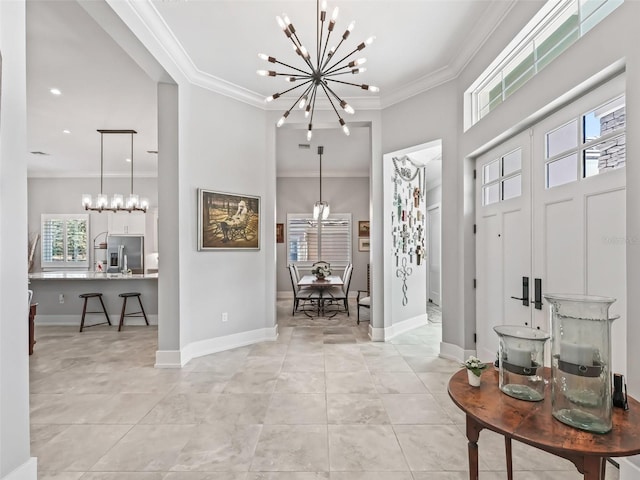 foyer featuring light tile patterned floors, baseboards, an inviting chandelier, and ornamental molding