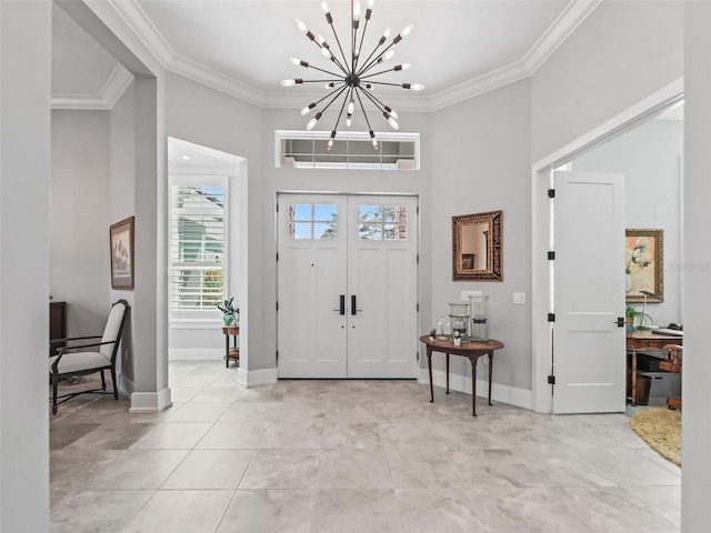 entrance foyer with light tile patterned floors, baseboards, a chandelier, and ornamental molding