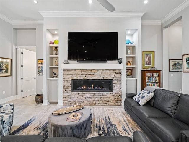 living room with baseboards, built in shelves, ornamental molding, and a fireplace