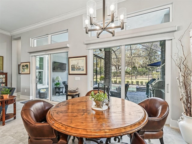 dining room featuring a notable chandelier, a healthy amount of sunlight, baseboards, and ornamental molding