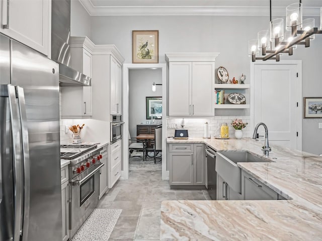 kitchen featuring open shelves, a sink, appliances with stainless steel finishes, wall chimney range hood, and decorative backsplash