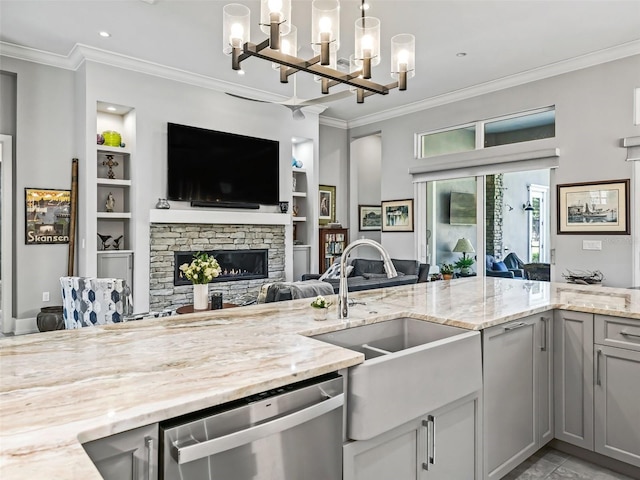 kitchen with open floor plan, gray cabinets, built in shelves, and stainless steel dishwasher