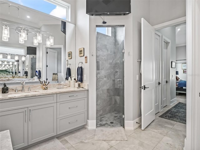 ensuite bathroom with vanity, baseboards, ensuite bath, a stall shower, and a wealth of natural light