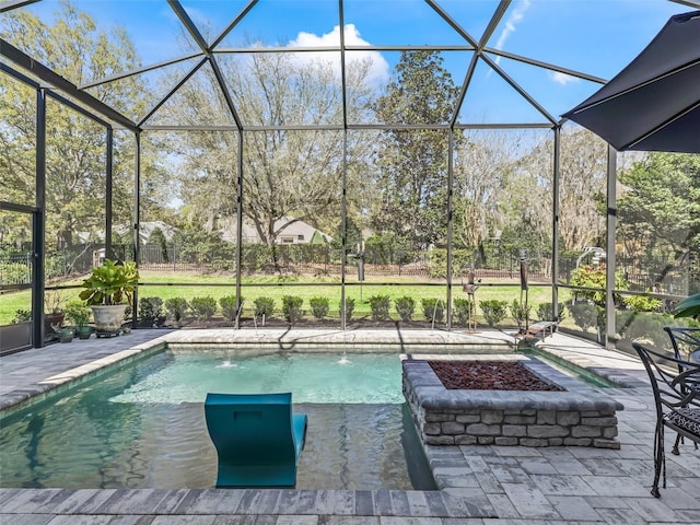 outdoor pool featuring glass enclosure and a patio