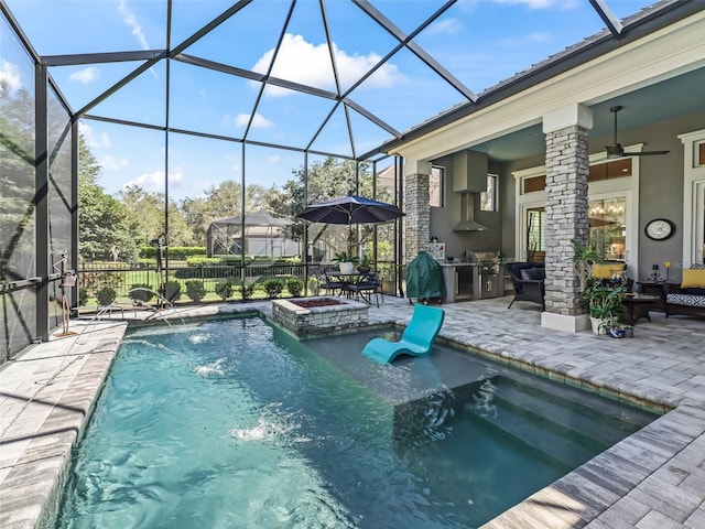 view of swimming pool featuring glass enclosure, a patio, area for grilling, and a ceiling fan