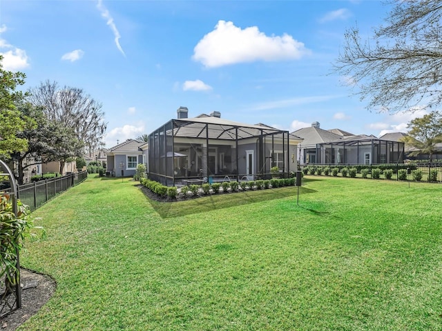 view of yard with a lanai and a fenced backyard