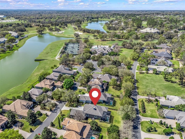 birds eye view of property featuring a residential view, a water view, and view of golf course