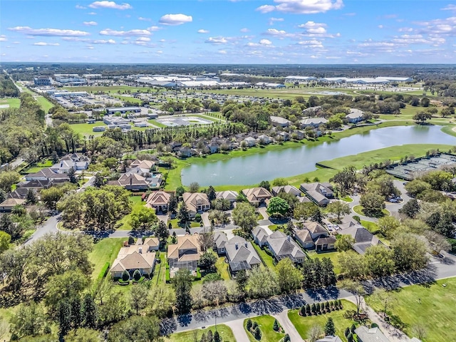 drone / aerial view featuring a residential view and a water view