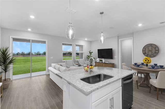 5270 NW 33rd Pl, Ocala, FL 34482 - kitchen with a sink, open floor plan, dishwashing machine, recessed lighting, and wood finished floors