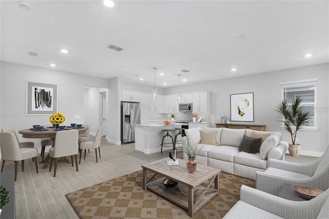 5270 NW 33rd Pl, Ocala, FL 34482 - living room with recessed lighting, light wood finished floors, and baseboards