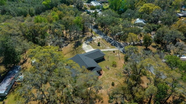 drone / aerial view with a wooded view