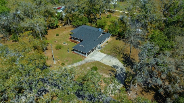 bird's eye view with a wooded view