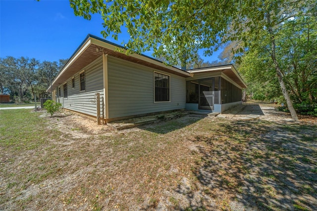 back of property featuring a sunroom