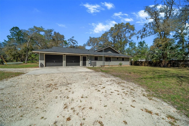 single story home featuring a front lawn, fence, a garage, and driveway