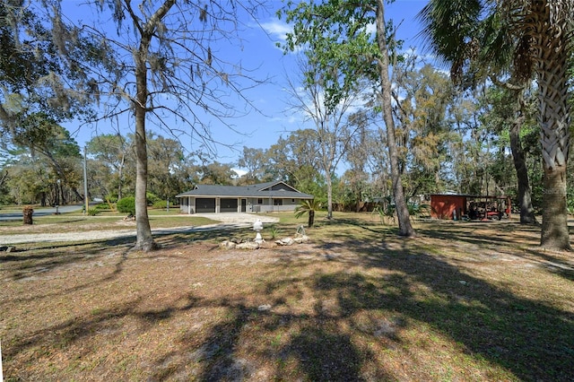 view of yard with a garage and a sunroom