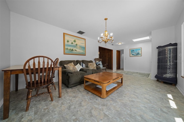 living room with an inviting chandelier, a skylight, baseboards, and visible vents