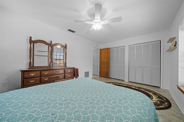 bedroom with visible vents, multiple closets, baseboards, and ceiling fan