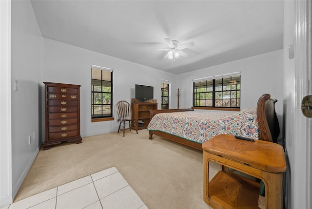 carpeted bedroom with baseboards and ceiling fan