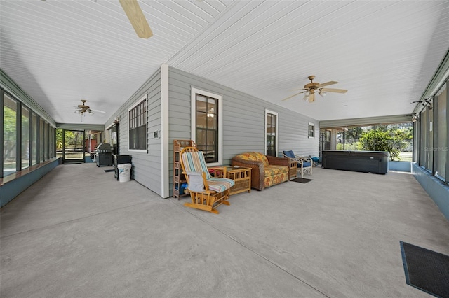 sunroom with a wealth of natural light and a ceiling fan