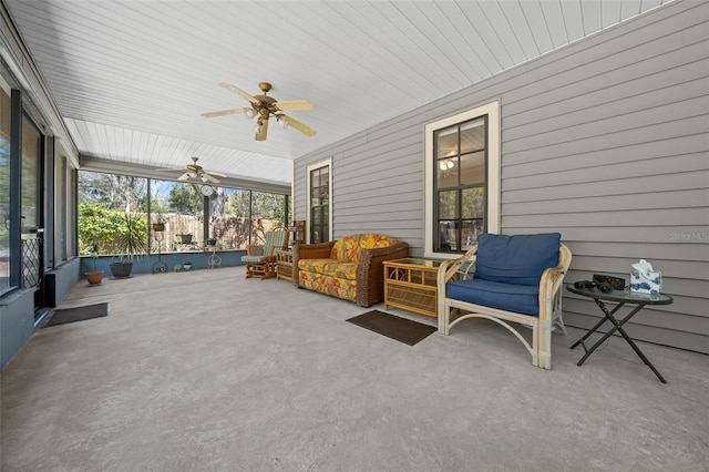 sunroom featuring plenty of natural light and a ceiling fan