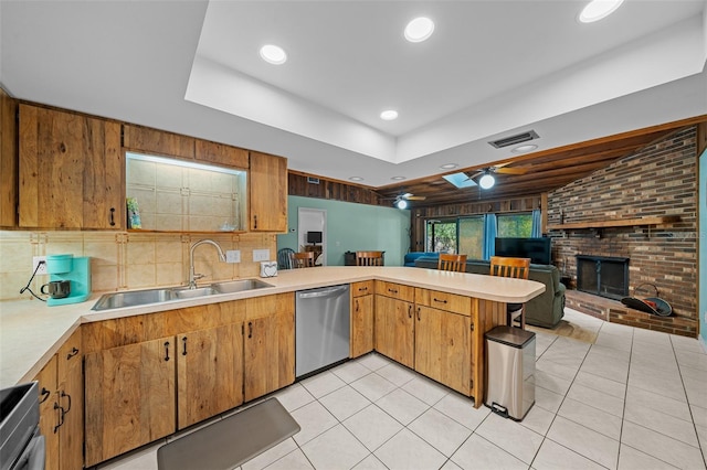 kitchen featuring visible vents, a sink, light countertops, and stainless steel dishwasher