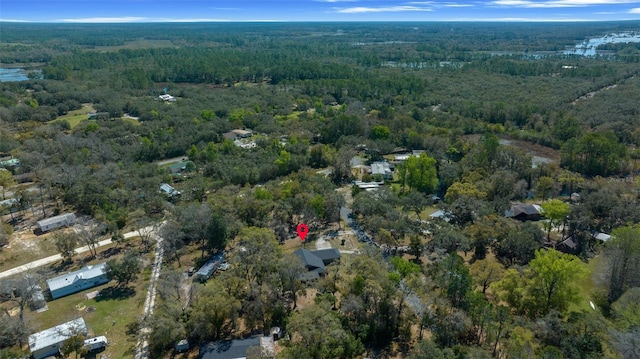 birds eye view of property featuring a forest view