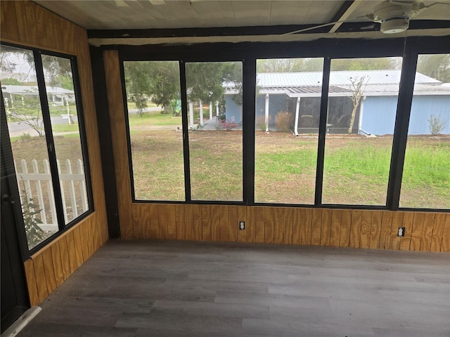 unfurnished sunroom with plenty of natural light and ceiling fan