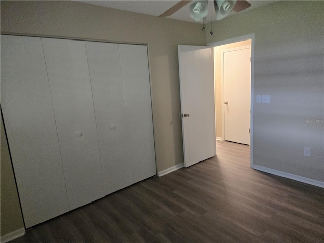 unfurnished bedroom with a closet, baseboards, and wood finished floors