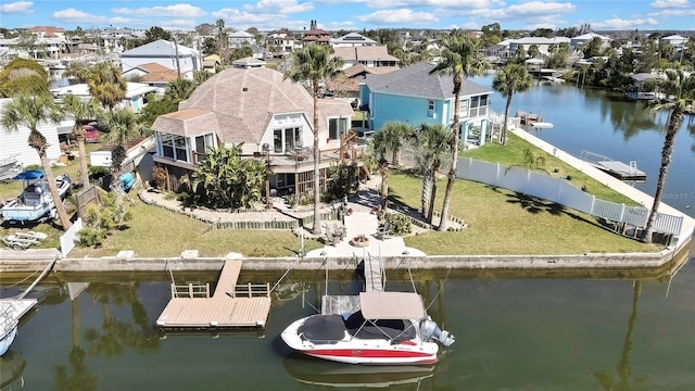 drone / aerial view with a residential view and a water view