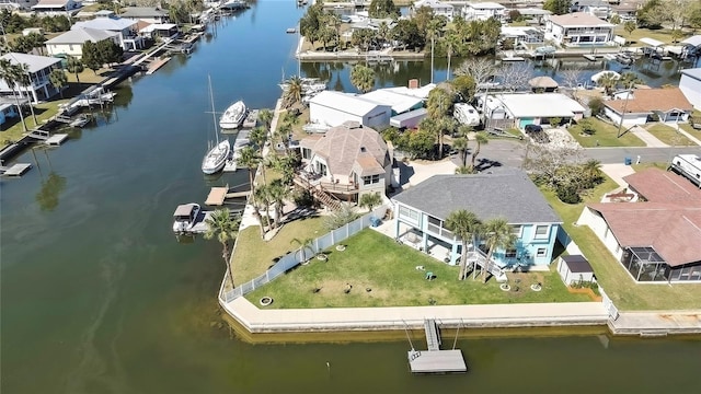 drone / aerial view featuring a residential view and a water view