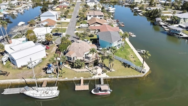 drone / aerial view featuring a residential view and a water view