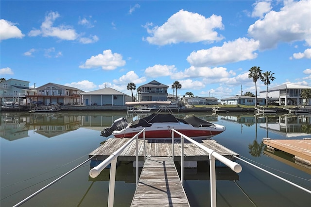 dock area with a residential view and a water view