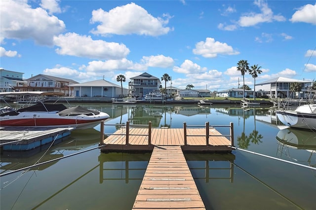 view of dock with a residential view and a water view