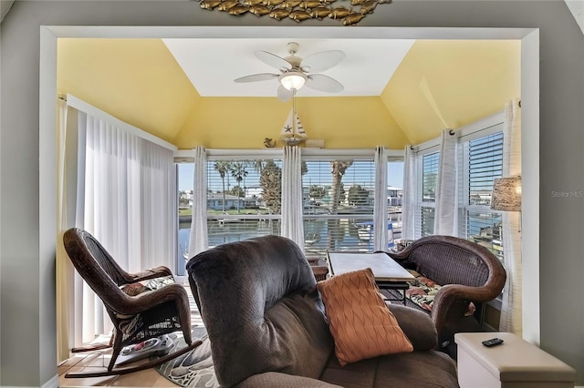 sunroom with ceiling fan and vaulted ceiling