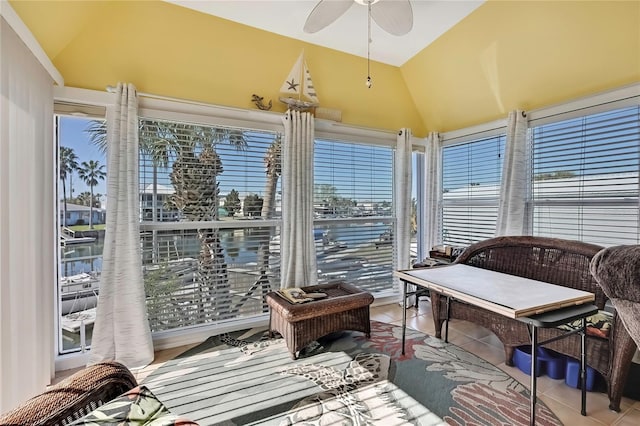 sunroom with lofted ceiling, plenty of natural light, and a ceiling fan