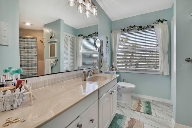 bathroom with vanity, baseboards, curtained shower, toilet, and marble finish floor