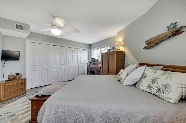 bedroom with visible vents, light wood-style floors, a closet, and a ceiling fan