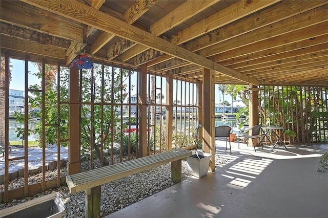 sunroom / solarium featuring a water view