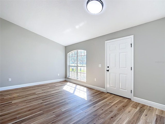 empty room featuring light wood-style floors and baseboards