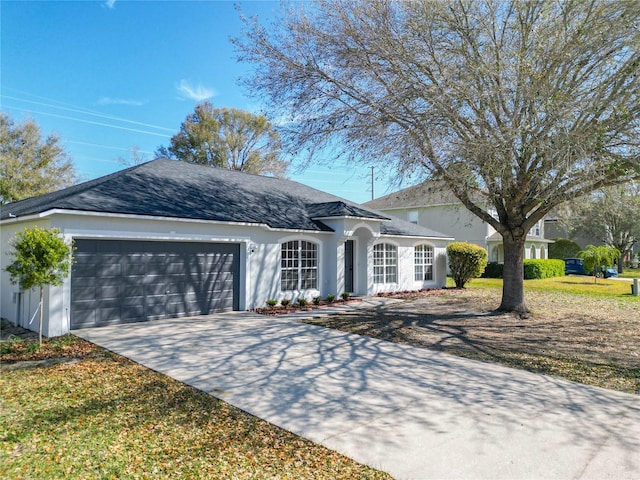 single story home with a garage, roof with shingles, concrete driveway, and stucco siding